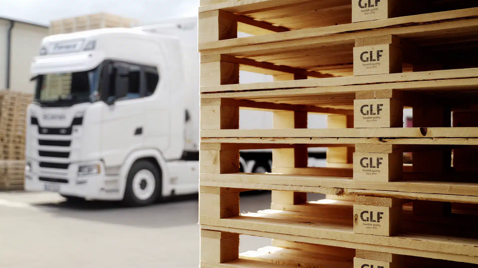 GLF packaging in the foreground with a truck ready for delivery in the background.